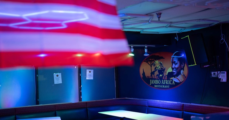 Dimly lit restaurant interior with blue ambient lighting