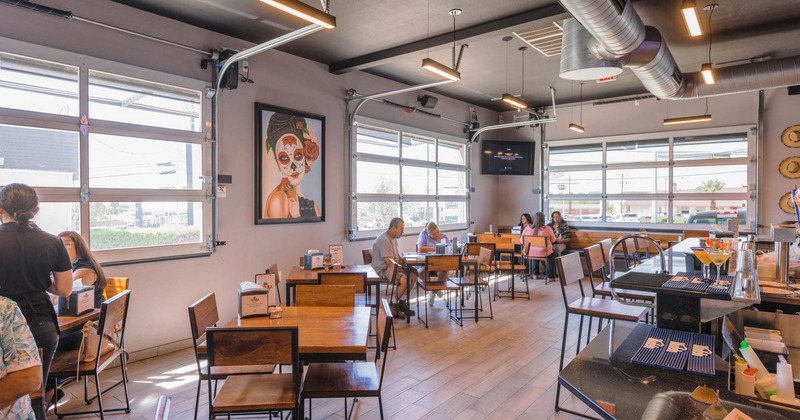 Interior, guests dining, staff member taking an order