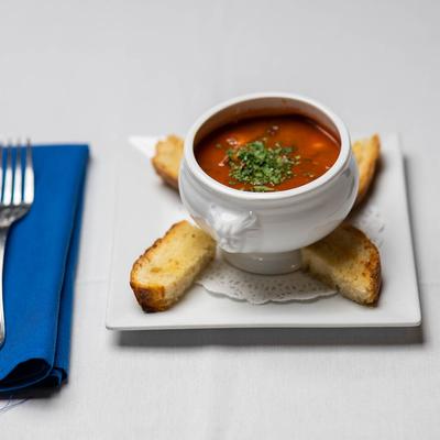 Shrimp in tomato sauce with capes and olives, side of garlic bread