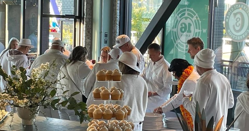 Interior, a group of people dressed in culinary uniforms standing around a table