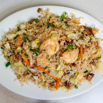 House fried rice with shrimp on top.