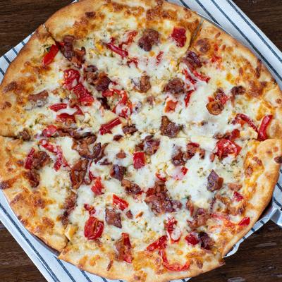 Pizza topped with clams, diced sweet peppers, and bacon.