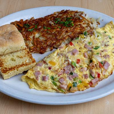 Works Omelette with a side of hush browns and a toast.