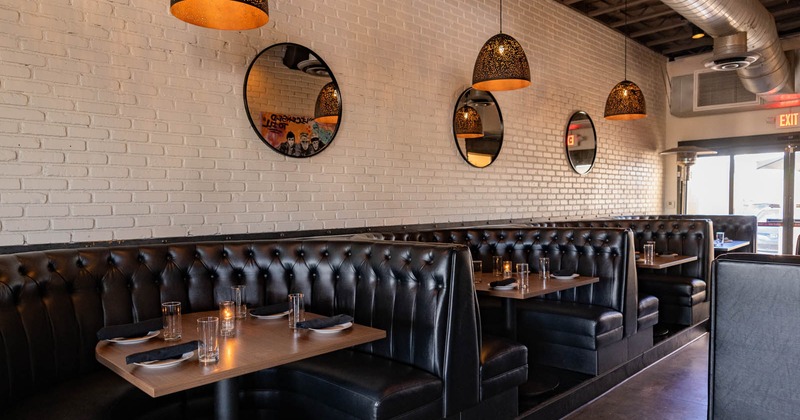 Interior, half circle button tufted booths with set tables