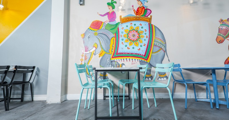 Diner table, chairs, draw on the wall behind