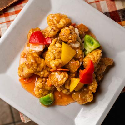 Sweet and Sour Boneless Pork with bell peppers and onion.