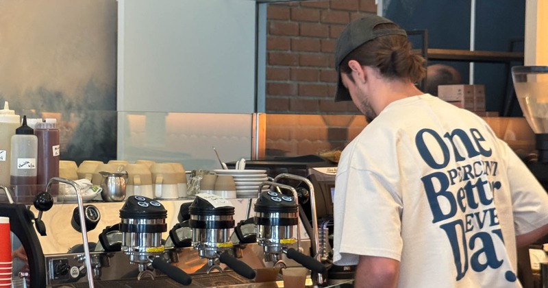 Employee operating the coffee machine