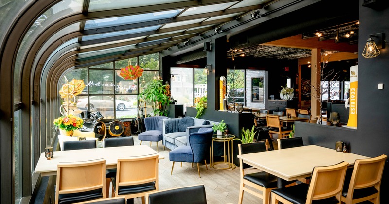 Interior, seating area, instruments in the corner and tables under arched glass canopy