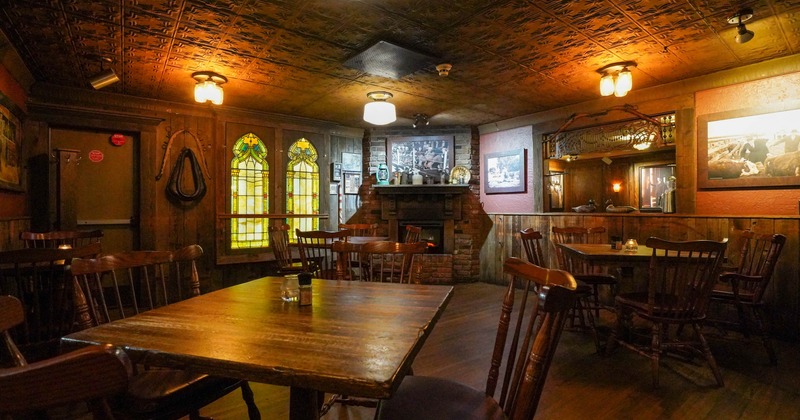 Interior, dining area, wooden top tables with chairs, red brick fireplace