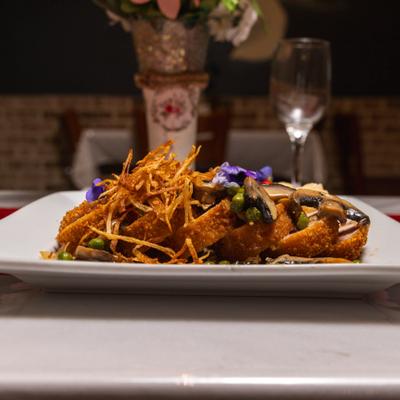 Chicken Cordon Bleu with flower garnish.