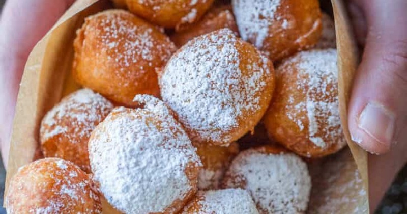 Round doughnuts dusted with powdered sugar
