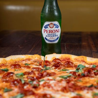 Hot honey and pepperoni pizza and a bottle of beer.