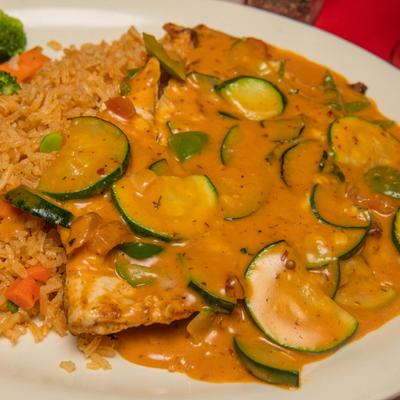 Grilled chicken topped with zucchini and creamy chipotle sauce, served with rice and veggies.