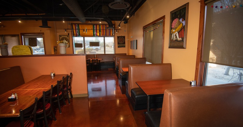 Interior space, dining area with dining tables and upholstered dining booths