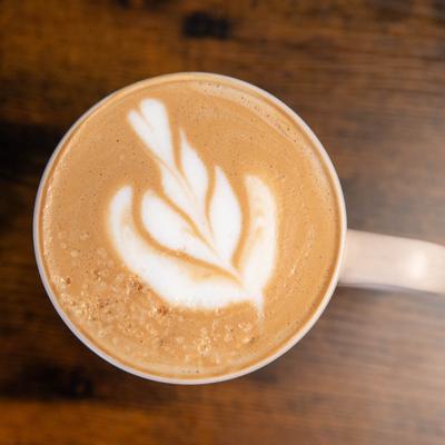 A cup of latte with leaf art.