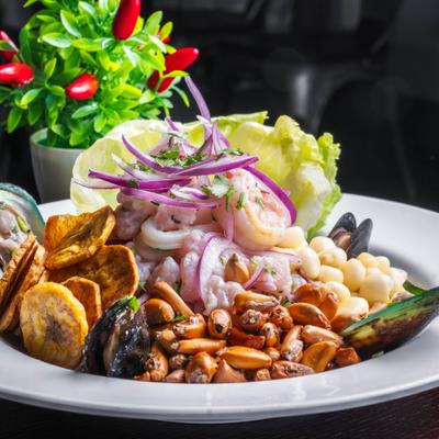 Mixed marinated seafood with nuts and fried plantains.