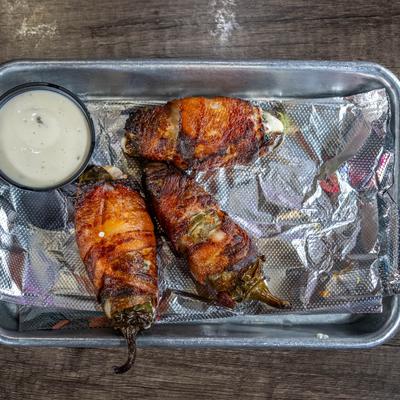 Fried bacon wrapped jalapenos stuffed with cream cheese.