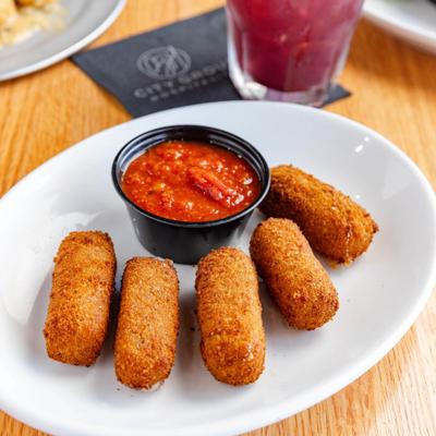 Mozzarella sticks served with marinara sauce.