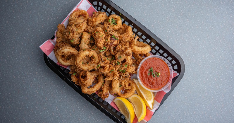Fried calamari served with lemon wedges and a dipping sauce