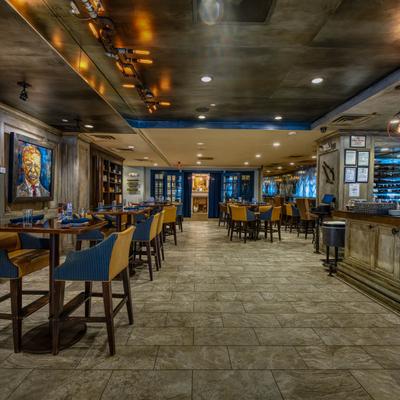 The interior of the bar, tables and chairs.