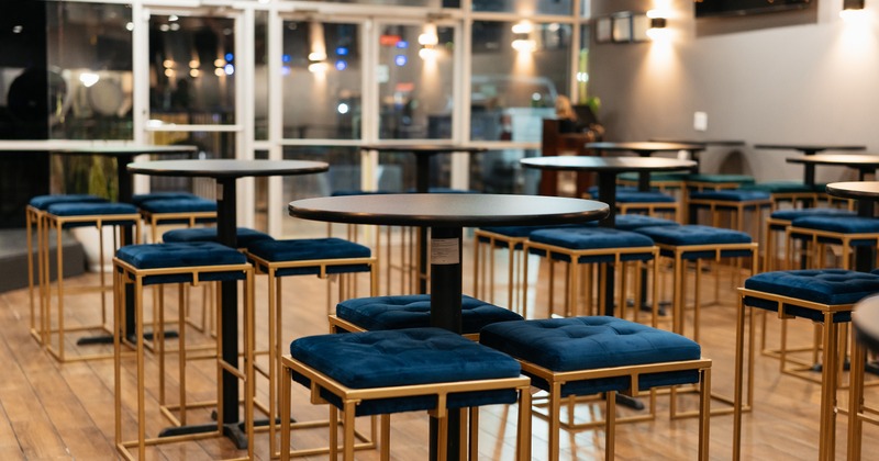 Interior space, seating area, high tables and metal stools