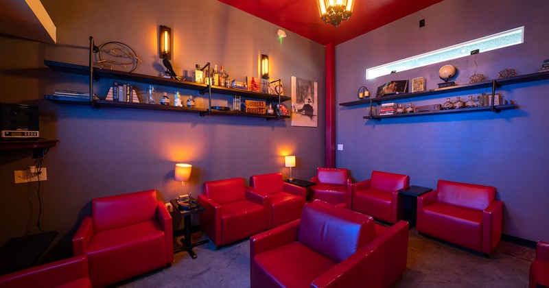 Interior, lounge area, armchairs in red leather, small coffee tables with lamps