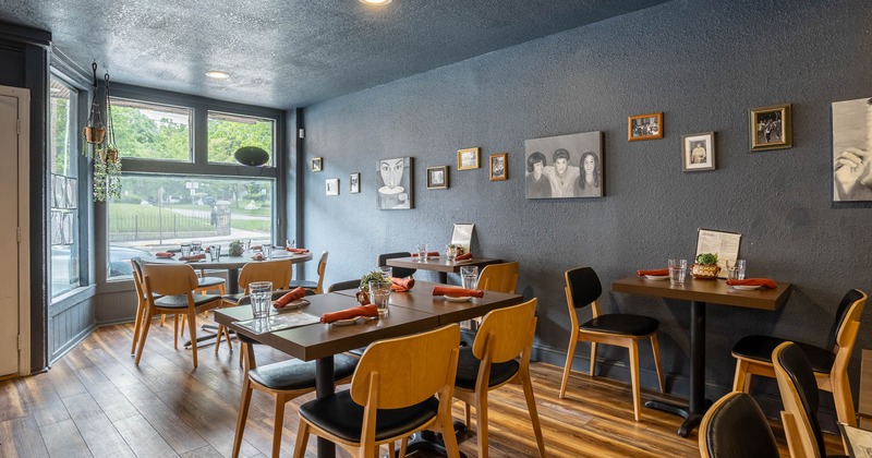 Cozy restaurant interior with wooden tables set for dining
