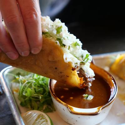 Birria taco with dipping broth.