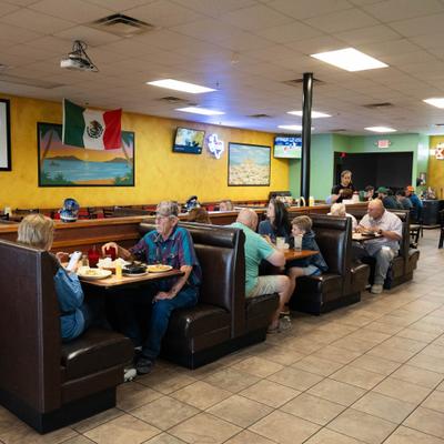 People sitting in booths and dining.