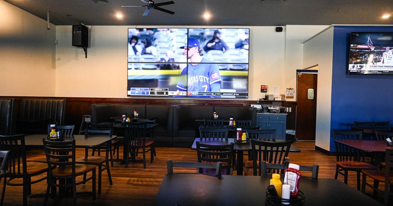 Dining area, big TV screens on the wall