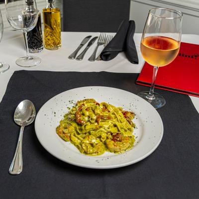 Fettuccine pasta in pesto sauce.