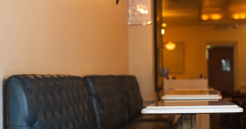 Interior, black leather seating and tables