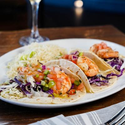 Grilled shrimp tacos with a side of rice.