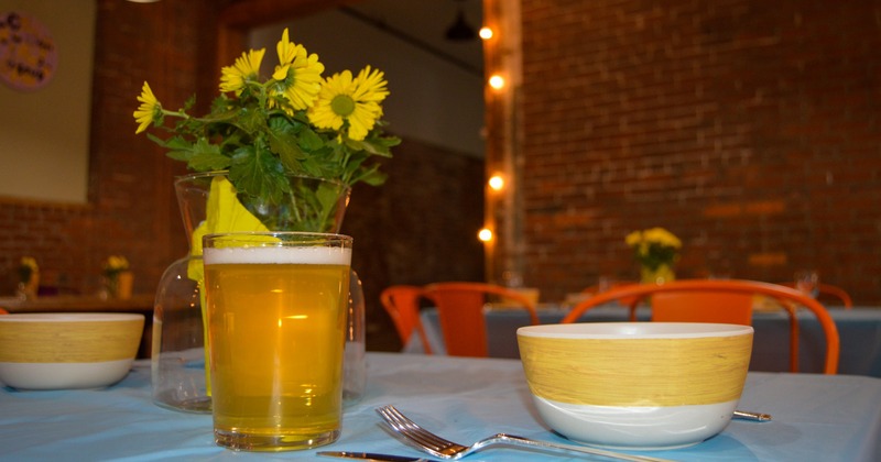 Bowls, utensils, flowers and a glass of beer