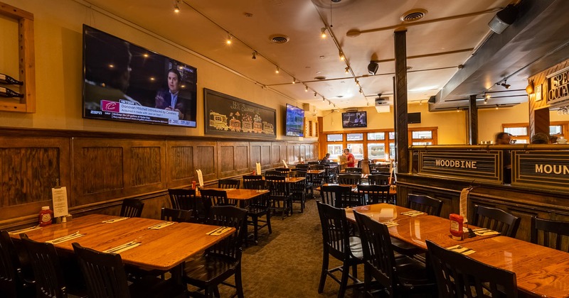 Interior, tables and seating, large TVs and decorations on wall