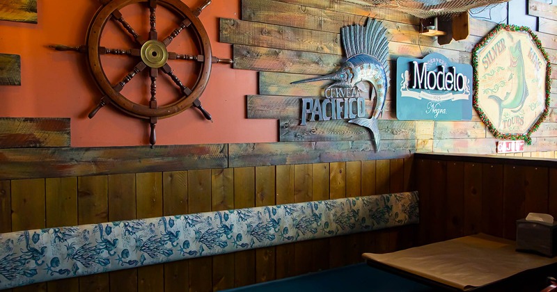 Interior, table and bench with decorations on the wall