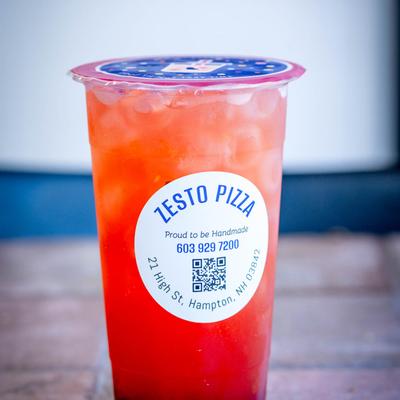Berry Tea served in a cup with Zesto pizza label.