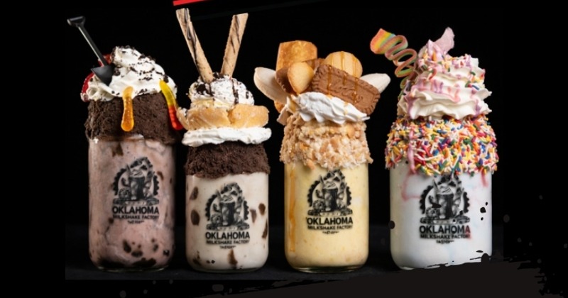 Assortment of milkshakes topped with various items and garnishes