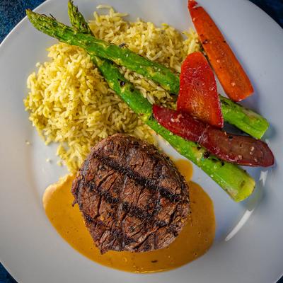 Filet Mignon with veggies and yellow rice.