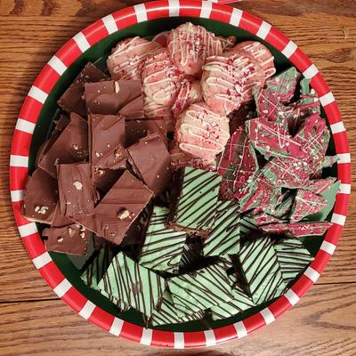 A platter of assorted holiday chocolate treats and cookies.