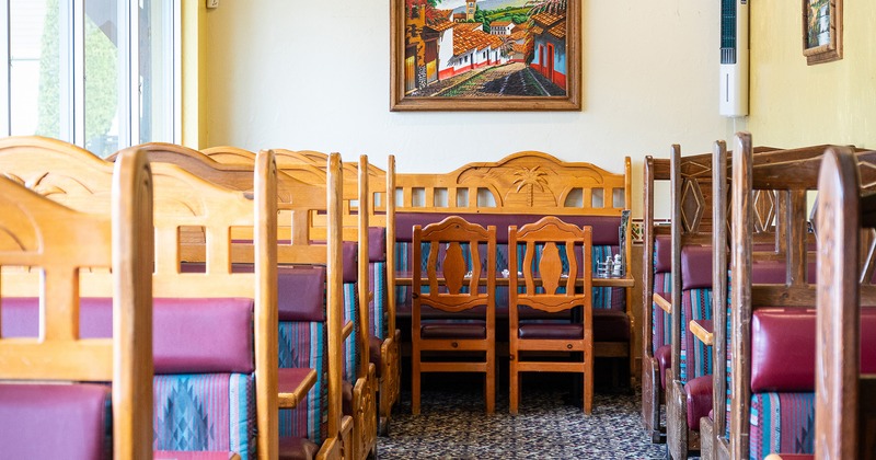 Upholstered wooden booths, tables, and chairs close up