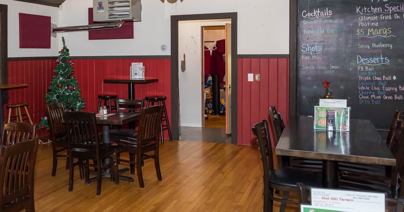 Interior, tables and chairs with menu written on the blackboard in the back