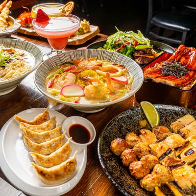A variety of dishes and drinks served on a wooden table.