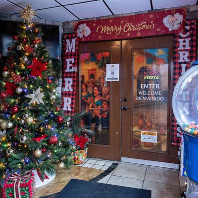 Festive entrance with a decorated Christmas tree adorned with red and gold ornaments.