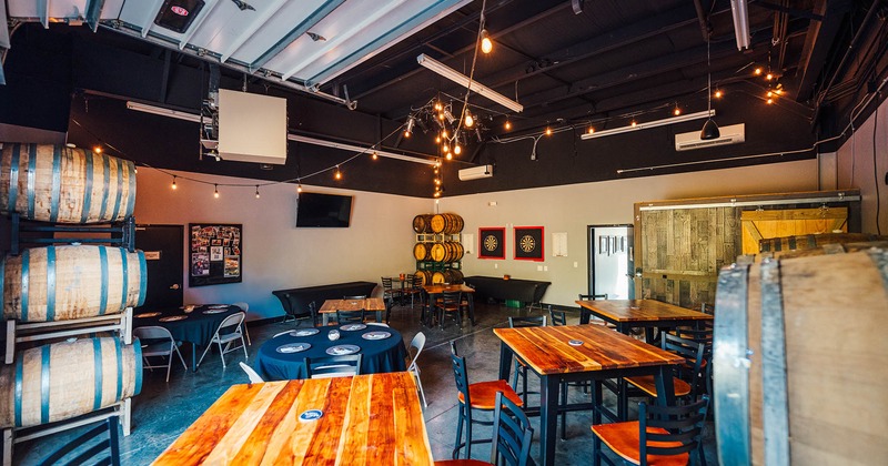 Interior, seating area, regular and high seating wooden top tables with chairs, lanterns