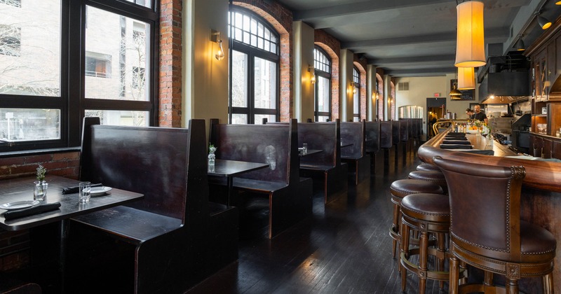 Restaurant interior with booths and a bar
