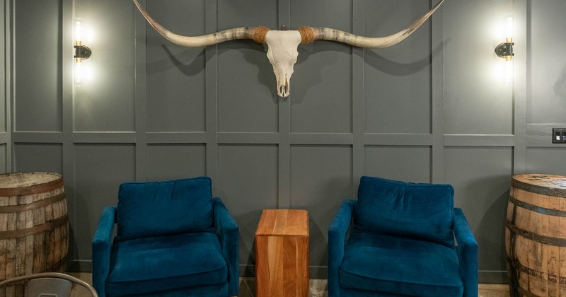 Interior, lounge area, low padded armchairs with coffee table, wooden barrels