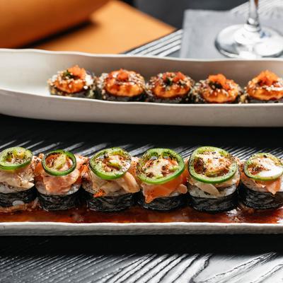 Assorted spicy sushi rolls on a table.