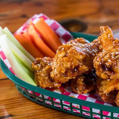 Jumbo Bone in Wings, with celery and carrots, close up.