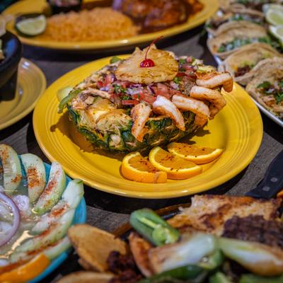 Shrimp pineapple bowl served with other Mexican dishes.